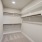 Large walk in closet with built in shelves