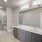 Spa Bathroom with dual sink vanity and walk in closet